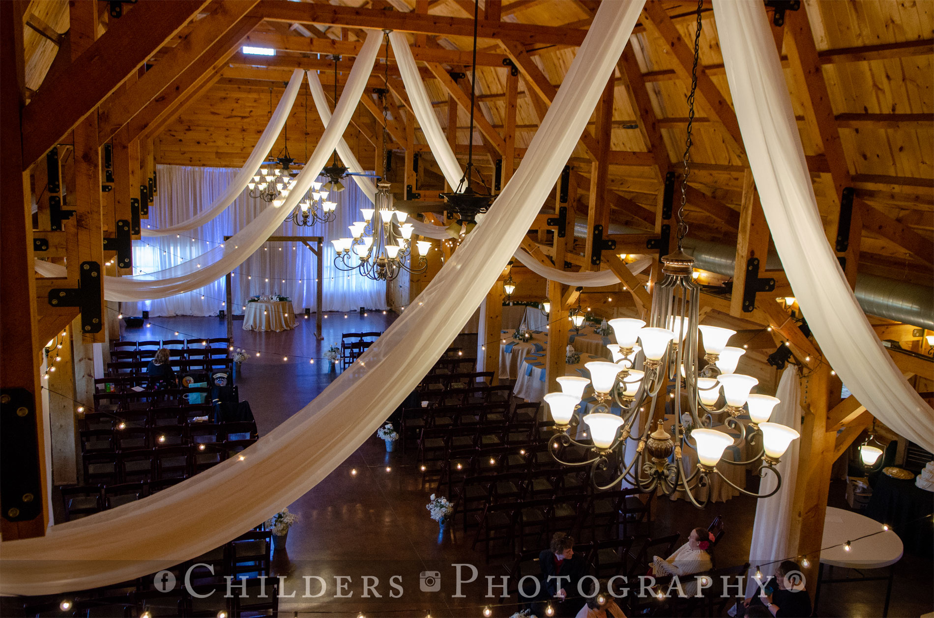 a room full of tables and chairs for wedding reception